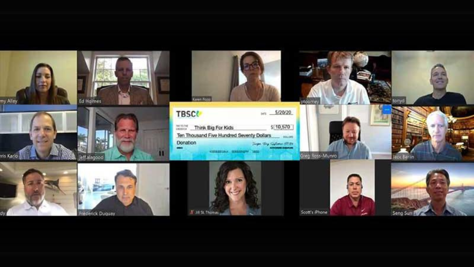 A virtual meeting with nine participants and a large check displaying a $10,570 donation for 